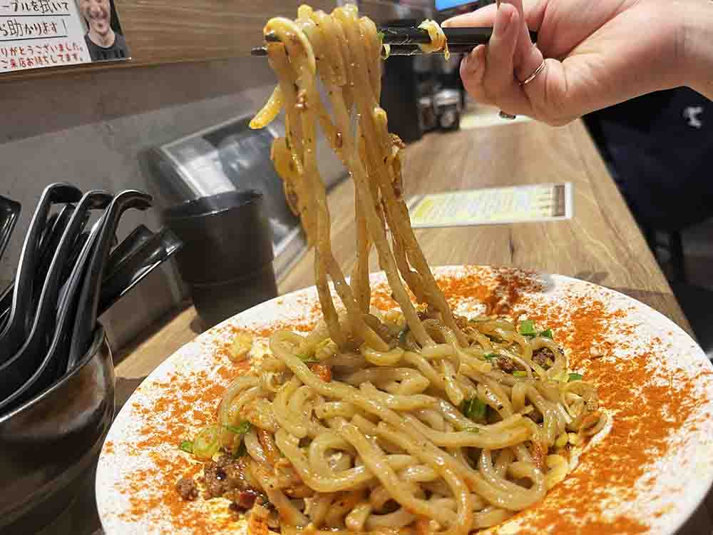 まぜそばを箸で食べている様子